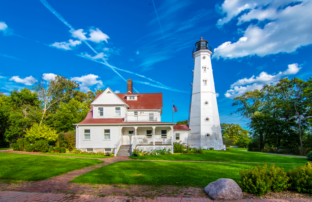 The North Point Lighthouse a white lighthouse attached to a white building with a red roof