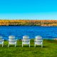 A line of white chairs overlooking the blue lake of Door County, one of the best places to visit in Wisconsin.