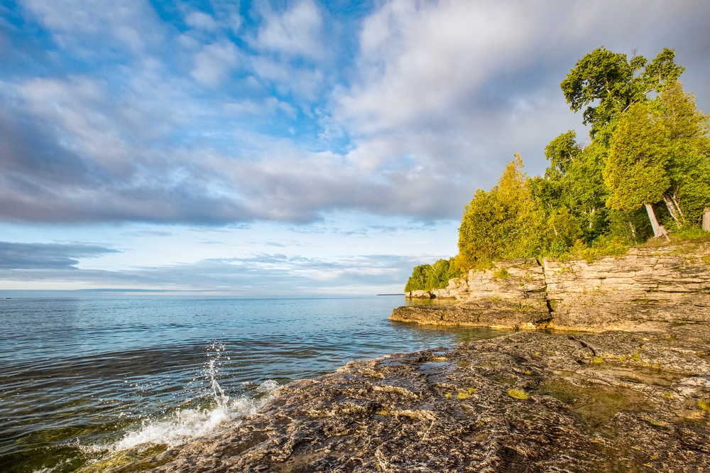 Looking out at the lake and rocky shore of Door County, one of the prettiest places to visit in Wisconsin.