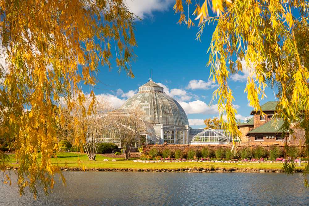 Looking across the water through fall foliage to the Anna Scripps Whitcomb Conservatory on Belle Isle, one of the prettiest islands in Michigan.