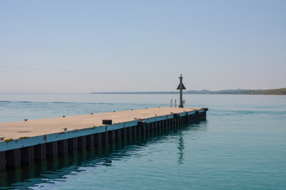 A boat dock jutting out into the water on North Manitou Island, one of the best islands in Michigan.