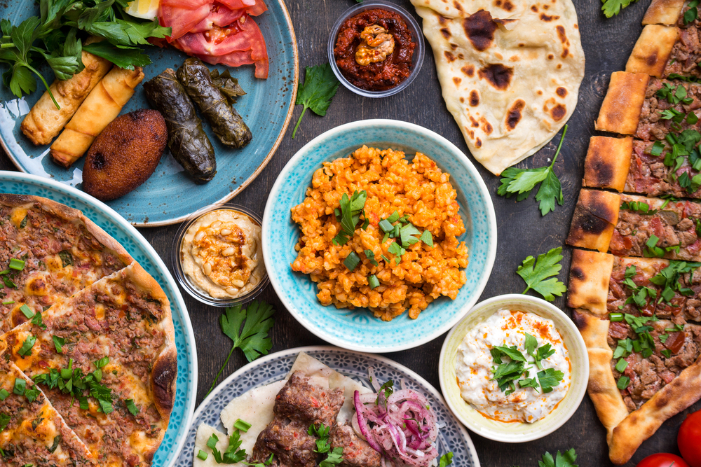 A wide selection of Middle Eastern dishes like saffron rice, pita bread, falafel, a flatbread, yogurt sauce, and hummus. Its similar to what you can find at restaurants in Lansing. 
