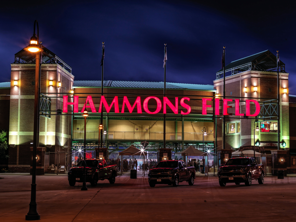 The outside of Hammons Field in the dark with the pink sign illuminated. One of the things to do in Springfield MO