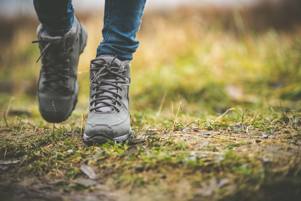 A person walking in hiking boots with a close up of the shoes in an article about things to do in Springfield MO