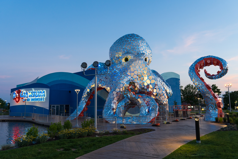 The Aquarium at the Boardwalk, featuring a giant octopus on top at dusk.