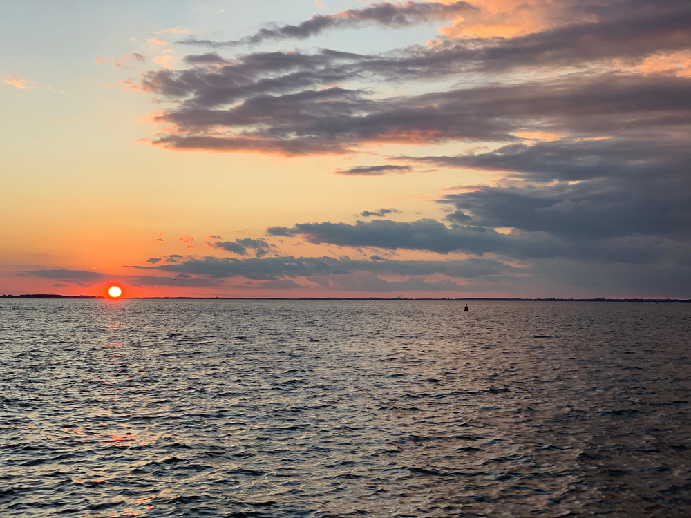 A cloudy sunset over the Sandusky Bay from Johnson's Island, one of the best islands in Ohio for history lovers.