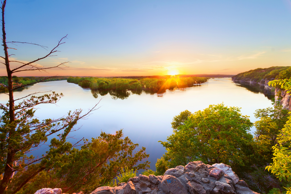 View from an outcropping down to the Lake of the Ozarks during a golden sunset.