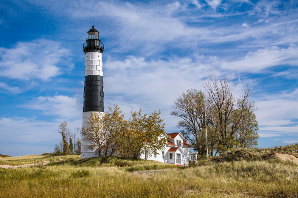 The black and white Big Sable Point Lighthouse and the Keeper's Quarters.