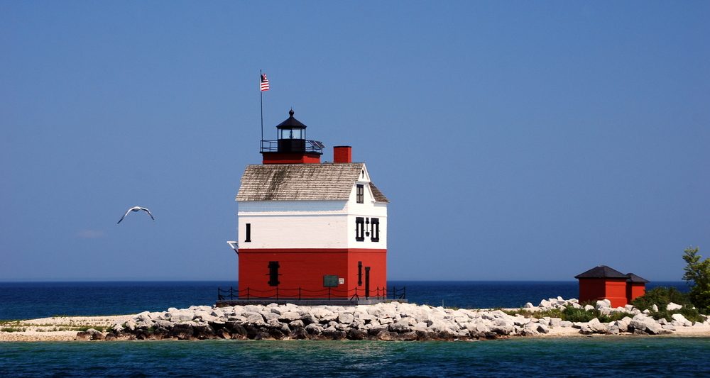 lighthouse with red bottom/white top, out on sandbar, is one of the best things to do in Mackinac Island