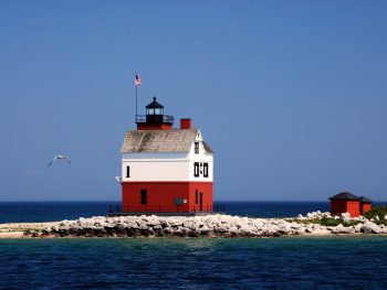 lighthouse with red bottom/white top, out on sandbar, is one of the best things to do in Mackinac Island