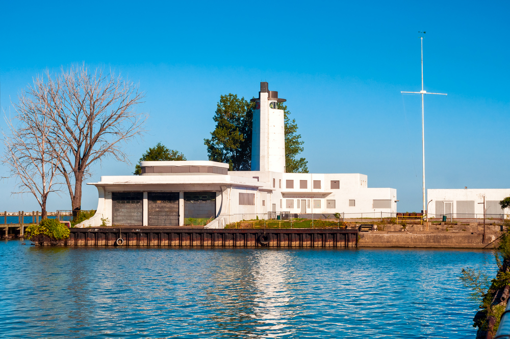 Looking over the blue water at the white coast guard station on Whiskey Island, one of the best islands in Ohio.