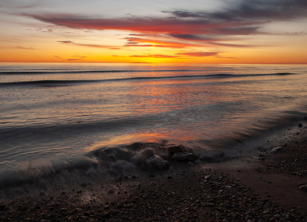 The sun rises over Lake Micigan from Newport Bay in Newport State Park, Door County, Wisconsin