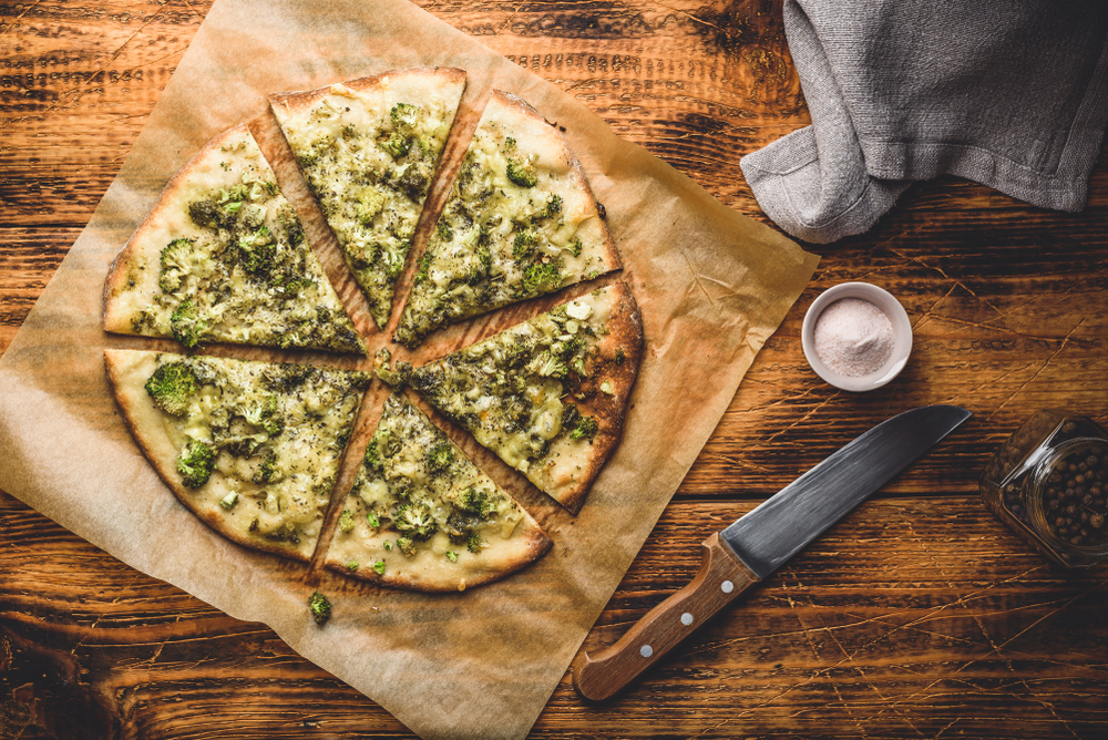 Sliced pizza with broccoli, pesto sauce, and herbs restaurants in ann arbor