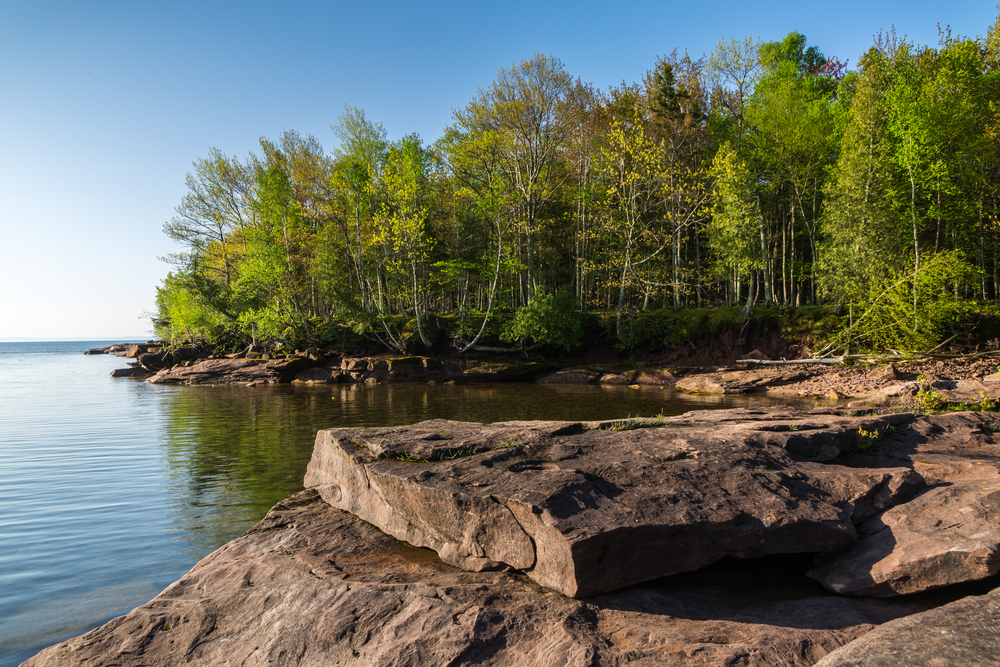 Large rocks and woods on the shore of the Apostle Islands in the Great Lakes.