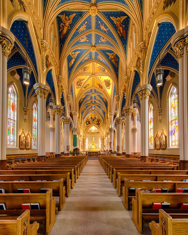 Looking down the aisle inside the Basilica of the Sacred Heart with beautifully painted ceilings.