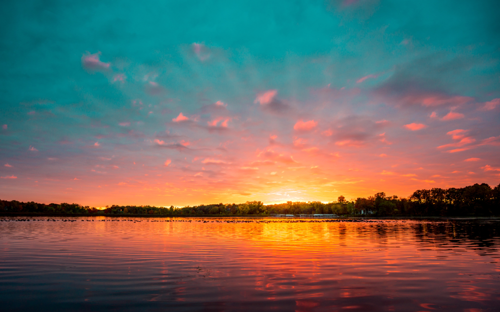 Pink and orange sunset over the water of Bear Island Lake. near one of the best Islands in the Midwest.