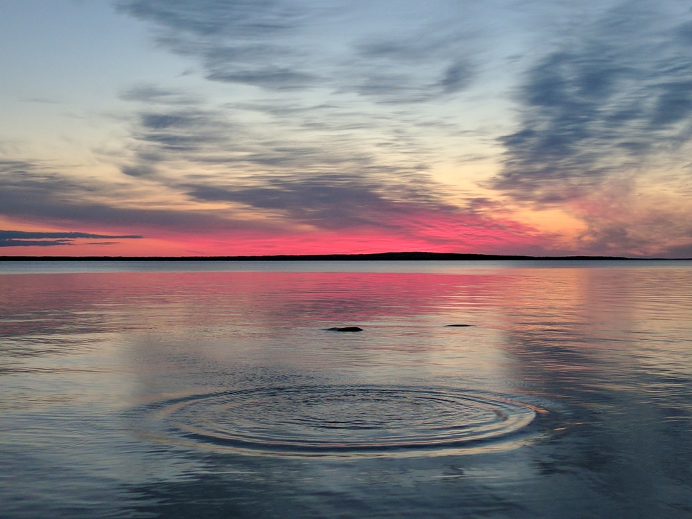 Pink and purple sunset over Lake Michigan with ripples in the water,