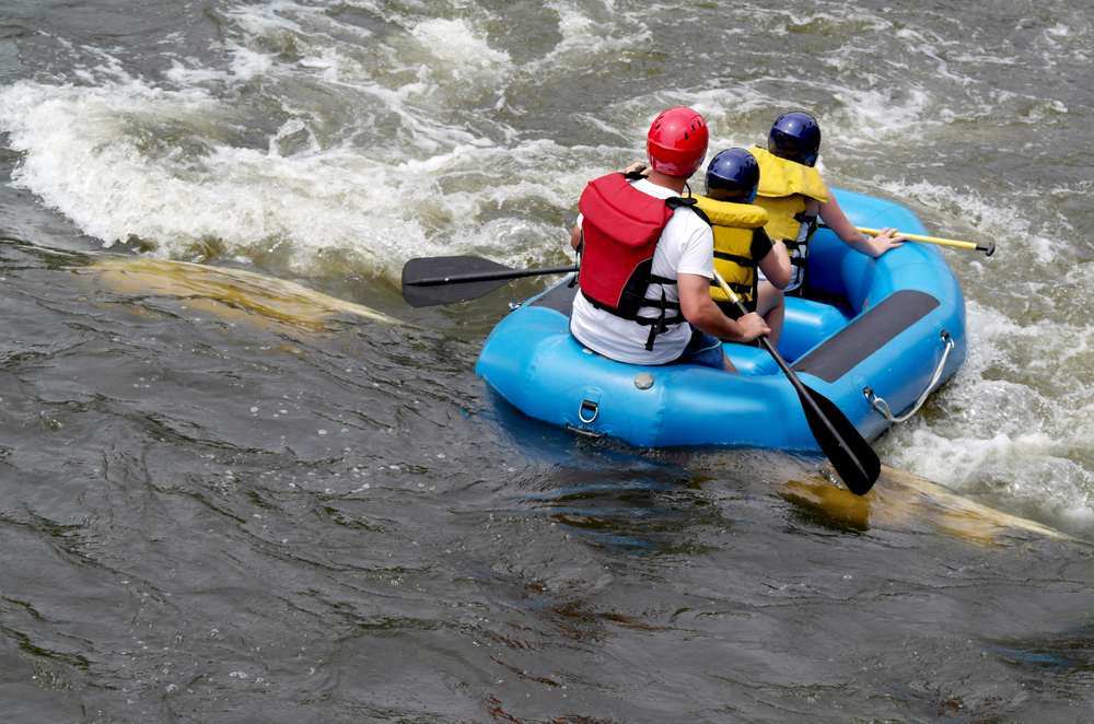 A blue raft going down the East Race Waterway, one of the most fun things to do in South Bend.