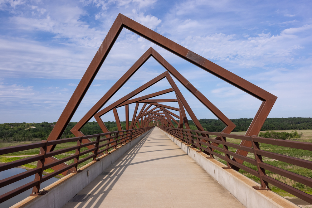 Looking down the High Trestle Trail Bridge with the river underneath while hiking in the Midwest.