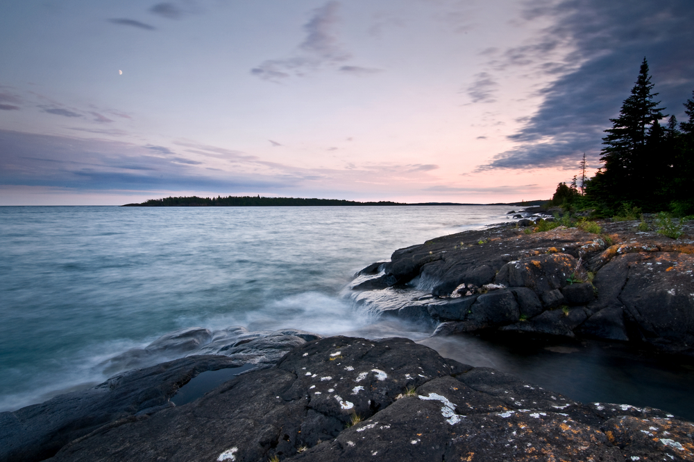 Purple sunset over the rocky shore of Isle Royale National Park.