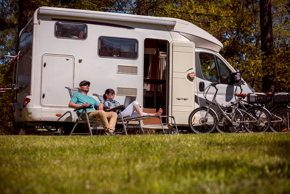 couple sitting on portable chair in front of RV camping in nebraska