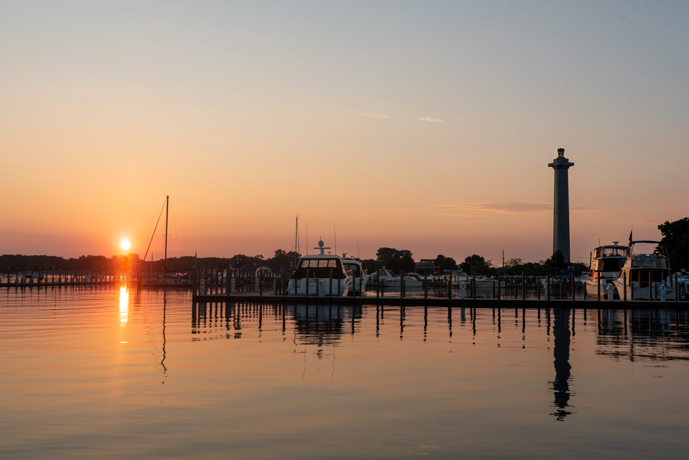 The Put-In-Bay harbor silhouetted against an orange sunset.