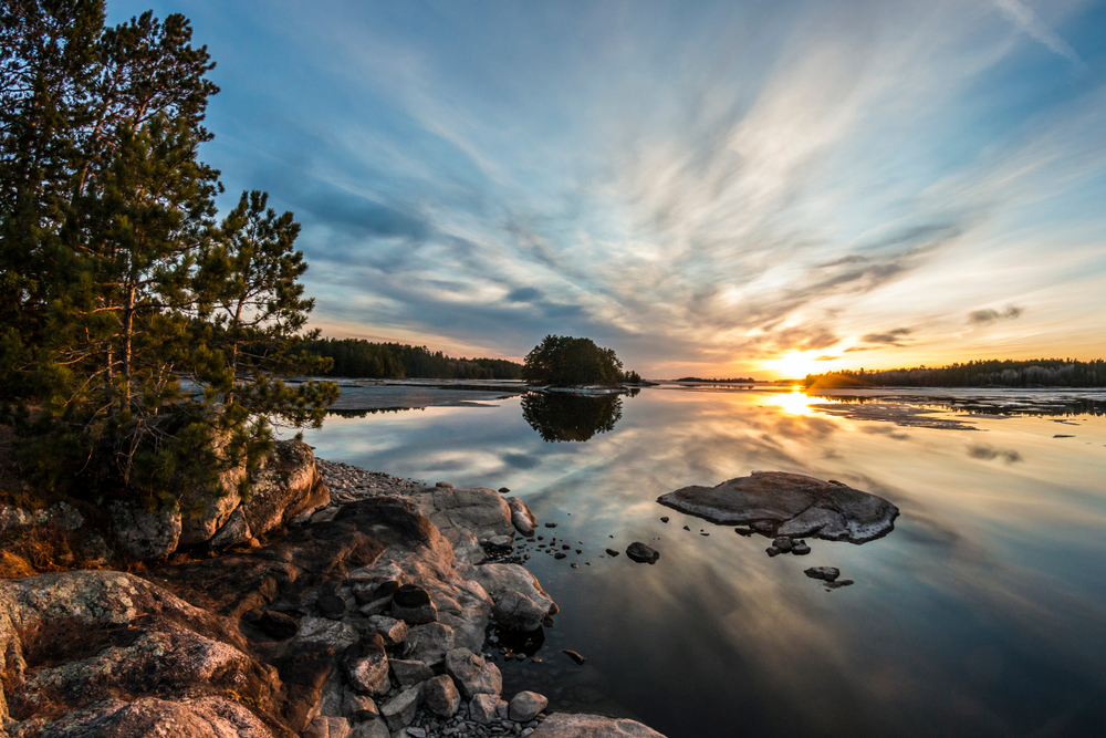 Sunset over the rocky shores and waters of Voyageurs National Park, where you can find some of the best islands in the Midwest.