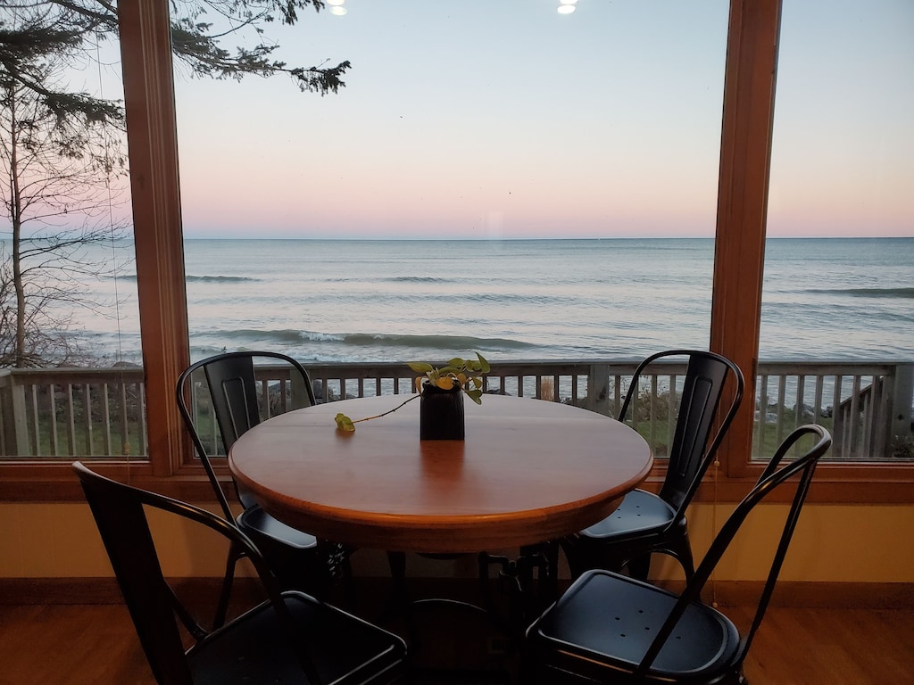 Table on a screened in porch with a view over the lake from one of the cozy cabins in Wisconsin
