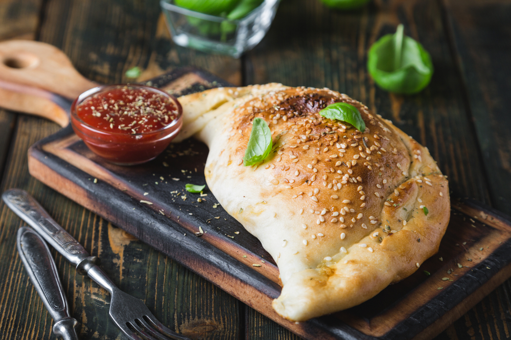 calzone on a plate with tomato sauce restaurants in cedar rapids