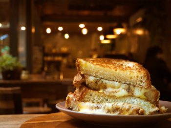 A closeup of a grilled cheese sandwich overflowing with cheese. Its similar to one you'd find in one of the best restaurants in Topeka.