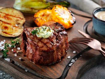 Steak served on wooden platter at an Appleton restaurant.