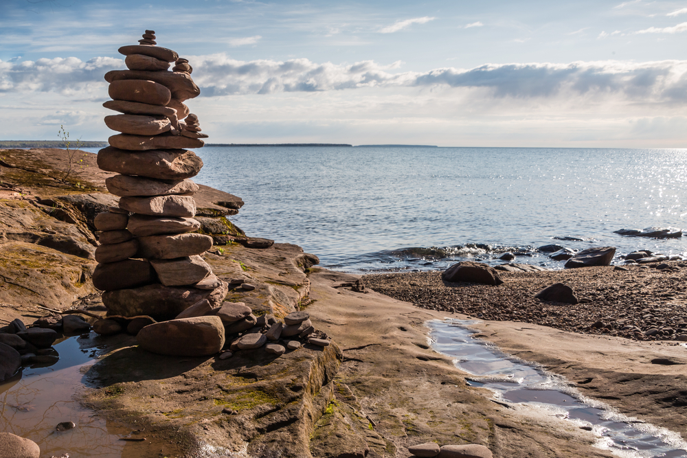 Rocks piled in a tower on a rocky outcrop overlooking the lake. at one of the state parks in Wisconsin