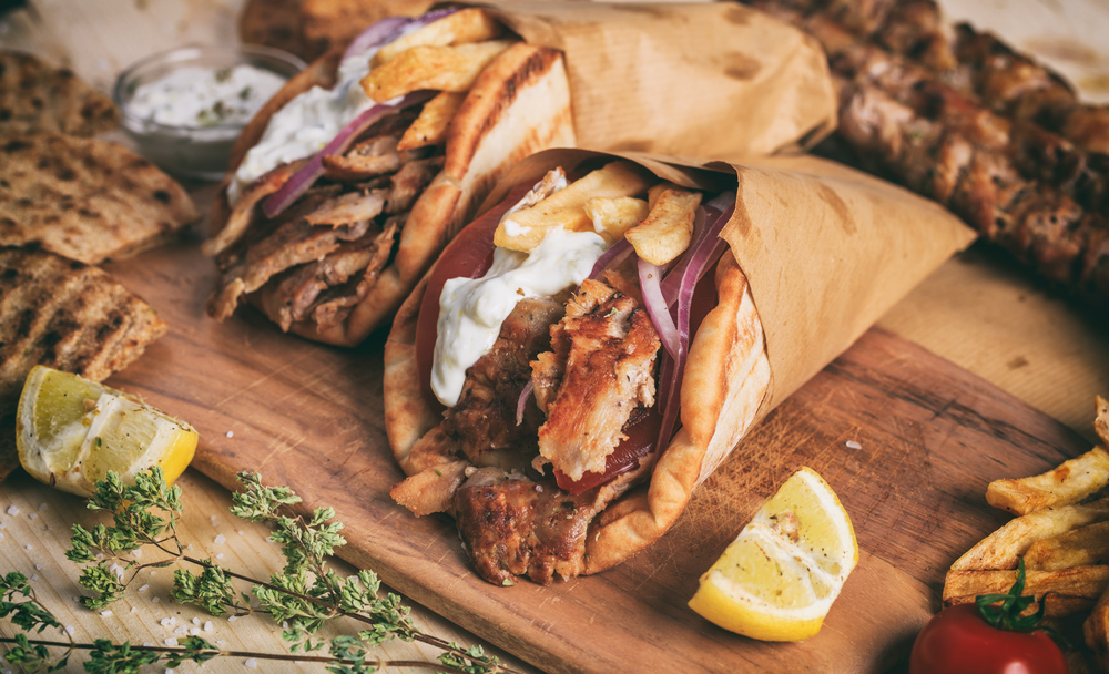 Greek chicken gyros wrapped in pita breads on a wooden background restaurants in sioux city
