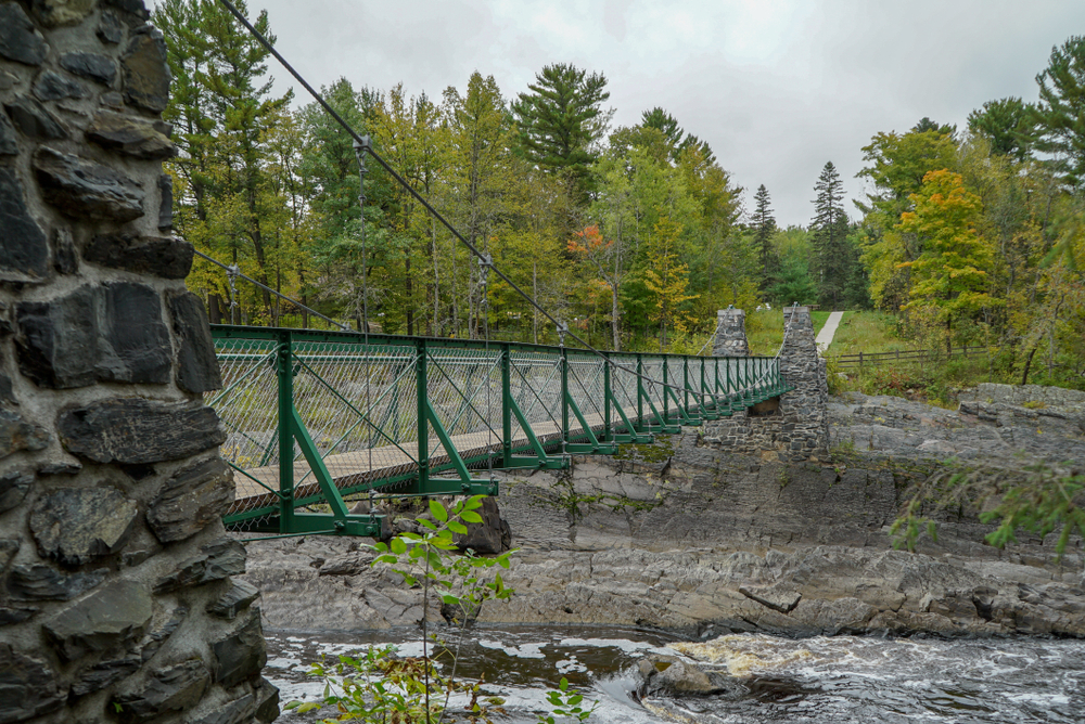 The Swinging Bridge going across a gorge with a river.