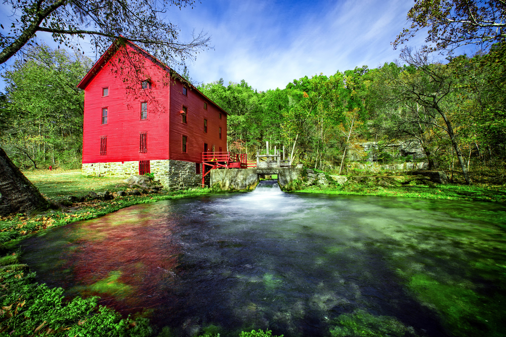 The bright, red Alley Spring Mill on the Ozark National Scenic Riverways, one of the prettiest national parks in Missouri.
