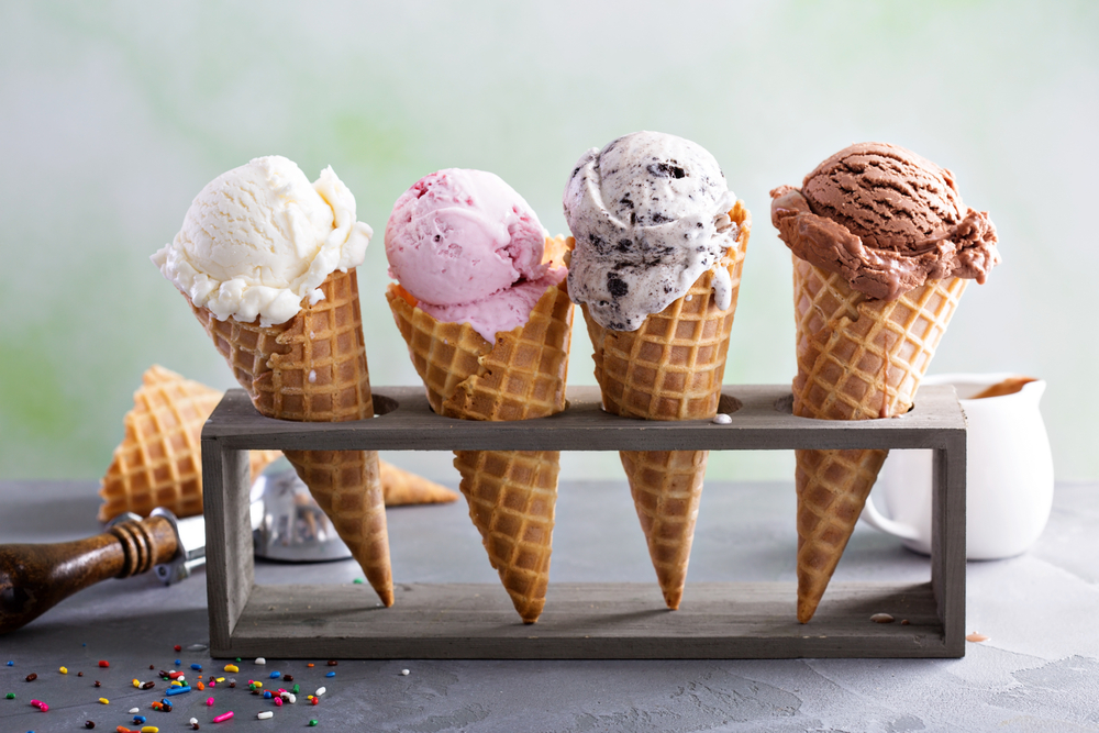 variety of  four ice cream scoops in waffle cones 