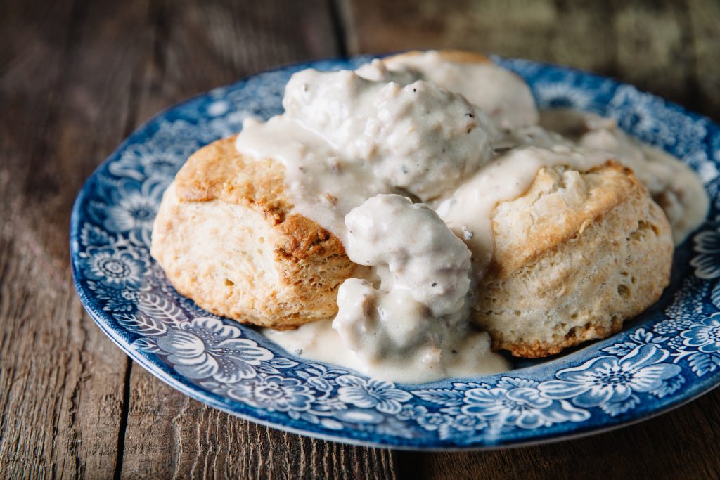biscuits with gravy over it served on a blue vintage plate restaurants in sioux city