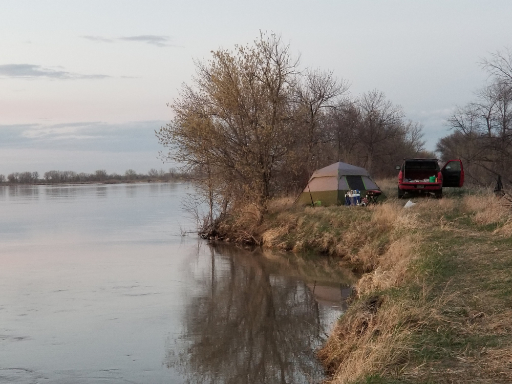 A tent on the side of the Missouri River. 
