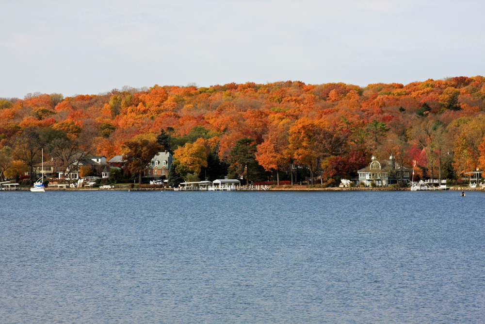 Lake Geneva shoreline with houses and fall trees. 