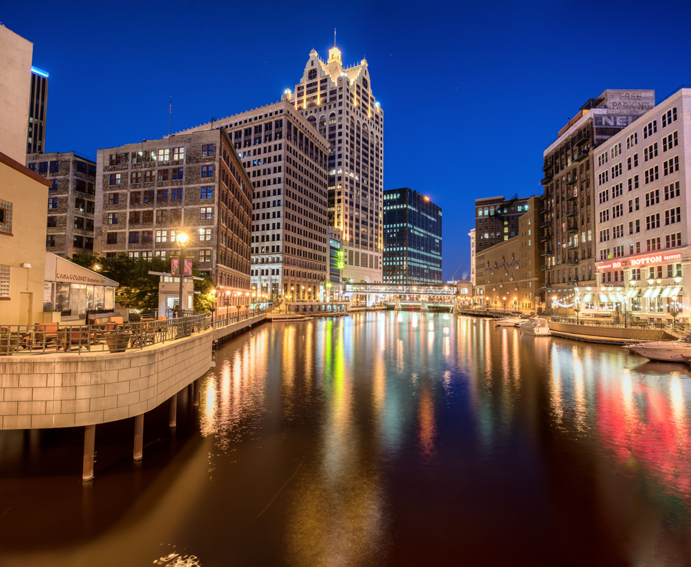 Building lit at night over the Milwaukee Riverwalk.  