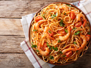 shrimp pasta on a plate over wooden table