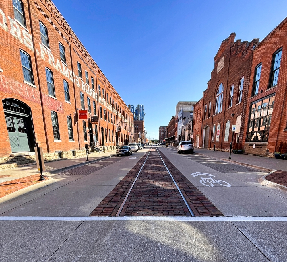 Orange colored buildings on both sides of a railway track towns in iowa