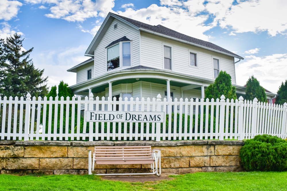 White House with fencing and a board saying Field of dreams towns in iowa