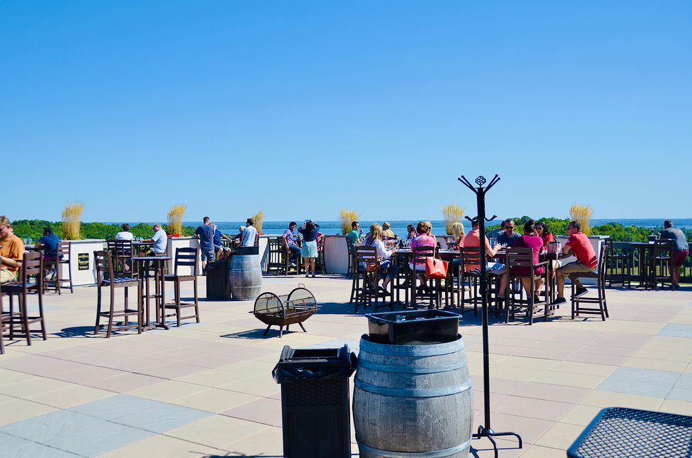 People enjoying the wine tastings and relaxing atmosphere at the Chateau Chantal Winery, on Old Mission Peninsula, Traverse City. In an article about wineries in Michigan 