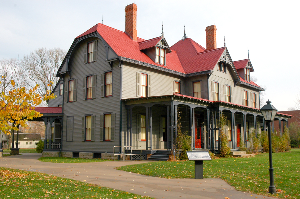 The grand Lawnview mansion with grey siding and a red roof.
