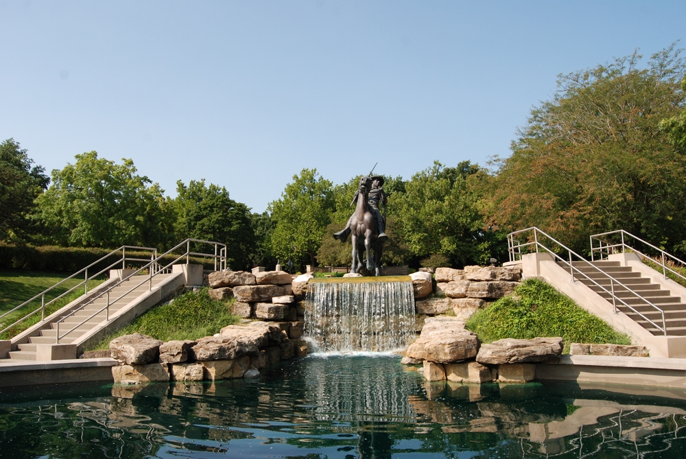 The Buffalo Soldier Monument next to a small waterfall and pond in Leavenworth, one of the best towns in Kansas.