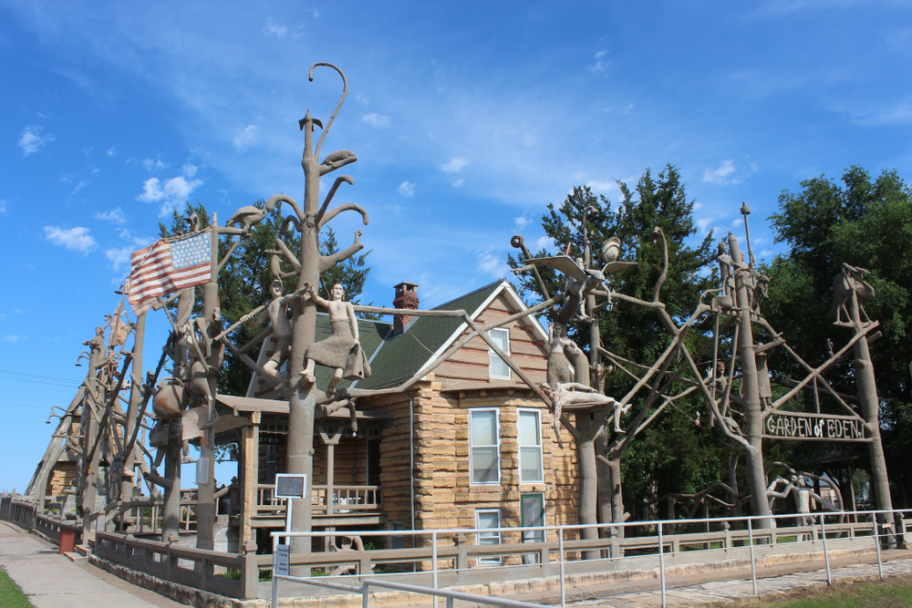 The Garden of Eden cabin with tree sculptures around it.