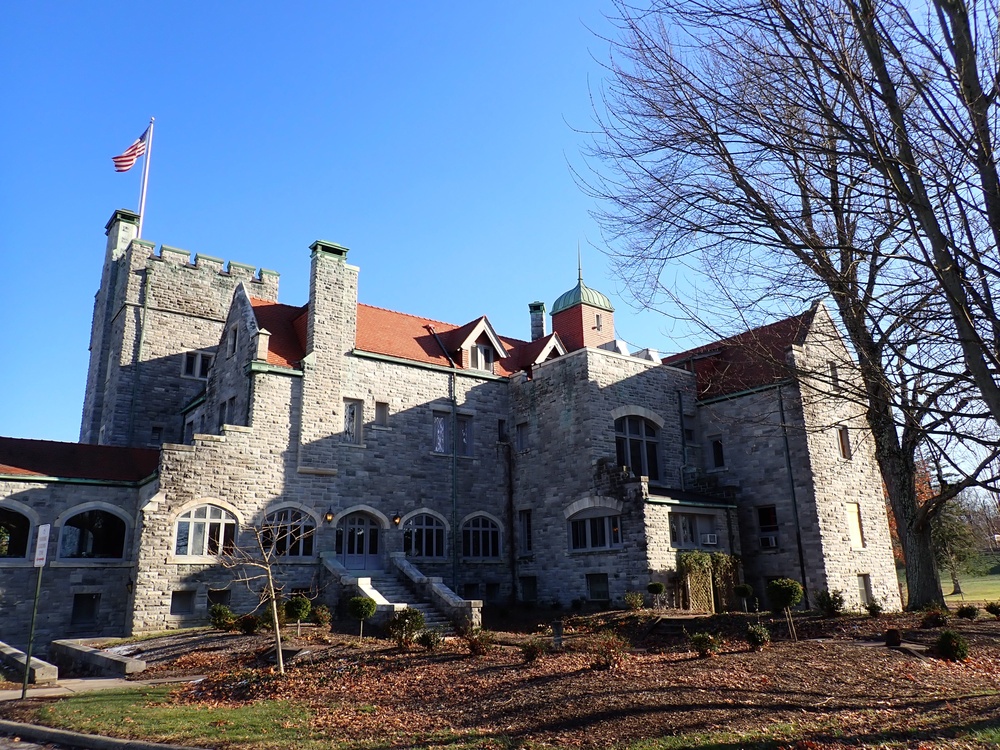 Castle from the back showing the yard and steps leading to a front door.  