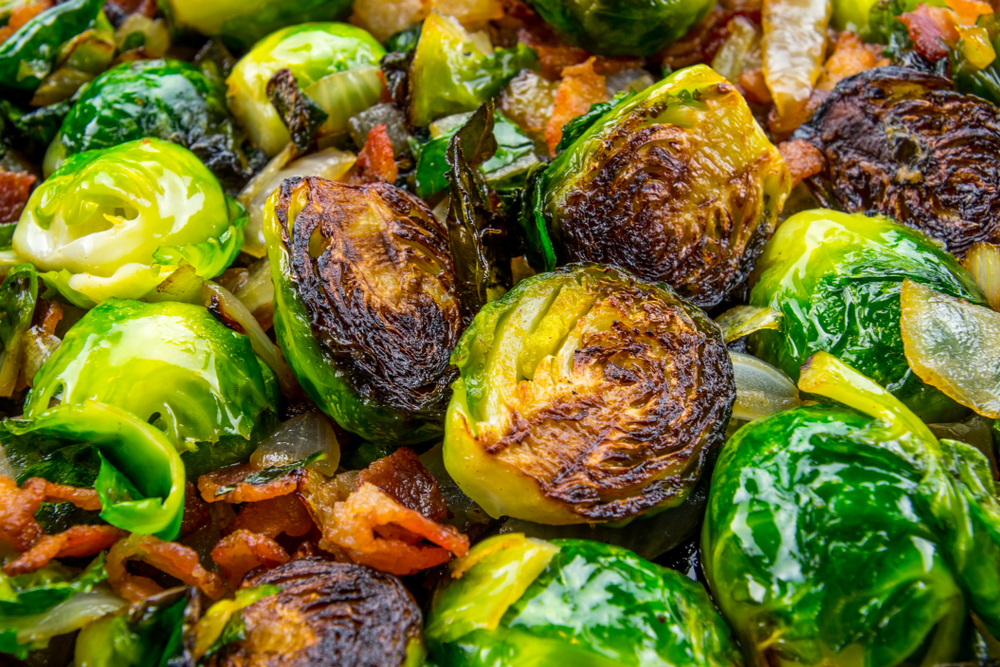 A close up image of charred brussel sprouts with bacon bits, similar to what you'll find at restaurants in Dayton. 