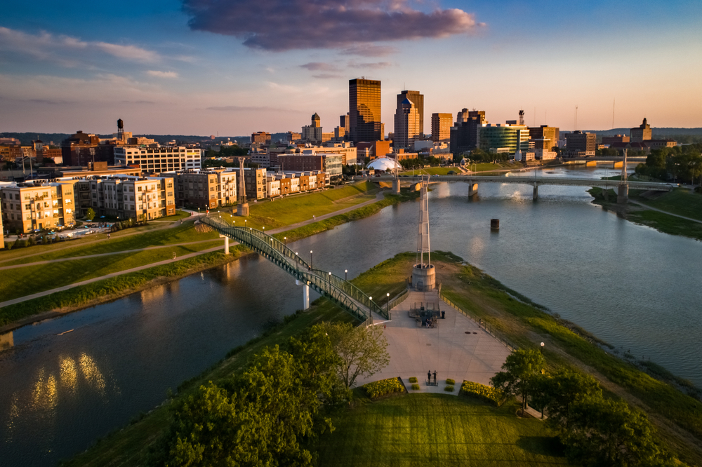 A view of the Dayton Ohio skyline along the rive as the sun sets. 